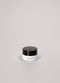 Small black and white jar on a light gray background